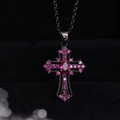 Macro shot of gothic cross pendant with pink zircons on black plated metal chain - Necklace / Black Pink Zirconia