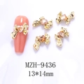 Golden 3D hollow bow nail art charms with heart gemstone detail on orange nail tip - Gold Bowknot Amber Heart(9436)