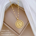 Detail view of gold sun face pendant with sparkling rhinestones on jewelry box - Sun Face Relief Style (C322) / Gold