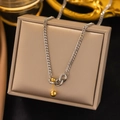Modern two-tone curb chain necklace with gold barbell pendant on a jewelry box - AH422 Balance Ball Contrast Steel