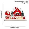 Detailed view of a wooden Santa Claus desk ornament with snow-covered red house and welcome text - WELCOME