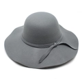 Detailed macro view of dark grey wool felt hat with wavy brim and side bow decoration - M (56-58cm) / Gray