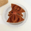 Detail of a large caramel brown velvet bow hair clip on a minimalist ceramic plate - Velvet Bowknot / Brown