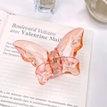 Translucent peach butterfly hair claw clip with golden spring on vintage books - Large 5.5cm / Pink