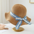 Handwoven straw sun hat with blue floral ribbon and bow on a display stand - M(56-58cm) / Blue Floral Lace Ribbon - Khaki