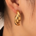 Retro hollow gold layered hoop earrings in stainless steel on a female model - Triple Layer Chunky Hoops (BJGE0707)