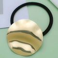 Elastic black hair tie featuring a large round textured gold metallic charm - Style 21 (Gold Round Irregular)