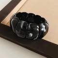 Macro shot of black marble acrylic geometric stretch bracelet with high polish finish - Marble Texture Black Style / Black