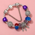 Detail of DIY charm bracelet featuring dreamcatcher pendant and purple crystal beads - Sl023318/1216-8