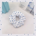 White scrunchie with blue polka dots made of soft fabric on a clean minimalist desk - 1043L White Blue Polka Dot Chiffon