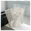 Detailed macro view of white mesh tote bag with reinforced handles and interior flowers - White