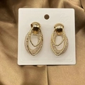 Detailed close-up of gold chain-link earrings with woven mesh on brown satin background - Double Layer Mesh