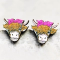 Macro shot of wooden bull head stud earrings with a pink bow on a grey stone surface - 5-Cow Head with Bow