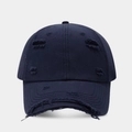 Detailed view of the distressed texture and ripped holes on dark blue baseball cap - Navy Blue