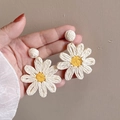 Detailed close-up of large woven daisy earrings with white petals and yellow centers - 19# Steel Needle-Off White-Yellow