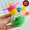 Detail of a glowing spinning top toy with green base and star patterns for kids - Glowing Mini Gyro