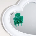 Elegant green marble acetate hair claw clip displayed on a heart-shaped mirror surface - Emerald