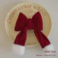 Small red velvet Christmas bow ornament with white faux fur pom-poms, 18cm length - Small