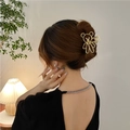Elegant gold metal bear hair claw clip accessory styled on a woman's hair bun - Gold Bear Head Metal(FJ116)