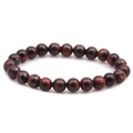 Macro shot of 8mm red tiger eye stone beads with natural texture on a white background - Red Tiger Eye