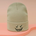 Beige knitted beanie with black XX smiley face embroidery and thick ribbed cuff - One Size / Beige