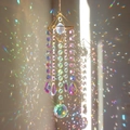 Macro shot of geometric crystal suncatcher reflecting vibrant rainbows on the wall - Four-sided Metal Frame + Sunflower