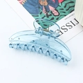 Transparent blue plastic hair claw clip with metal spring on a white surface - Transparent Blue