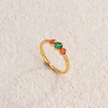 Golden titanium steel ring featuring a round green gemstone and orange side stones - Gold Red + Green Diamond