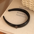 Minimalist black PU headband featuring a small leopard print butterfly pendant - Black