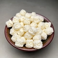 Detailed view of white lion head beads in a small wooden bowl for jewelry making - 13mm (Single) / Ivory