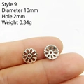 Macro detail of 10mm silver hollow flower spacer beads for DIY jewelry making - Style 9