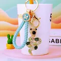 Detail of snake rhinestone keychain with blue braided lanyard and lucky coin pendant - Light Blue Lucky Rope + Teal Snake