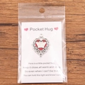 Pocket Hug heart pendant with red enamel and white butterfly on a greeting card - White Butterfly Red Heart