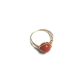 Detail of handmade gold wire-wrapped ring featuring a sparkling reddish-brown sandstone bead - One Size