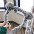 Cute grey curly plush headband with spherical pom-pom ears for women in close-up view - Blue Bear Ears
