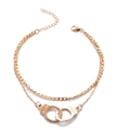 Golden double-layer anklet with freedom handcuff pendant on white background - Gold Double Layer