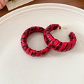 Detail of leopard print hoop earrings with woven texture on a decorative white plate - Silver Earring Post - Red