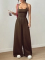 Detail of coffee brown sleeveless wide-leg jumpsuit with pleated waist on a model - Coffee