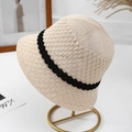 Beige knitted bucket hat with black ribbon stripe on gold display stand, chic sun protection - M (56-58cm) / Beige (Black Edge)