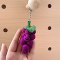 Handmade purple grape wool felt keychain with smiling face and green leaf detail - Purple Grape