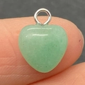 Polished green jade heart pendant with silver metal ring held on fingertip for DIY necklaces - 10mm / Green Aventurine
