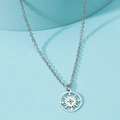 Close-up of compass pendant with hollow design on stainless steel necklace - Compass / Steel