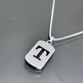 Macro shot of silver titanium steel necklace featuring a hollow rectangular letter T pendant - Letter T