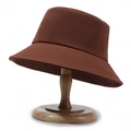 Brown canvas bucket hat with reinforced stitching on a natural wooden display stand - One Size / Coffee