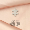 Detail of silver puzzle pendant with crystal inlay on pink silk including product dimensions - Steel