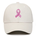 Close-up of pink ribbon embroidery on a beige cotton canvas baseball cap - Adjustable / Beige
