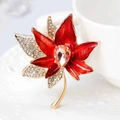 Elegant maple leaf brooch featuring red enamel and white crystals with golden finish - Style AL-32
