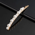 Elegant white faux pearl hair clip with gold metal base on a reflective black background - Mixed Sizes Pearl Curved Bobby Pin