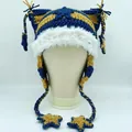 Detail of star pendants on striped cat ear beanie with fuzzy white faux fur trim - Blue and Yellow Striped
