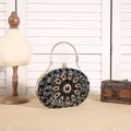 Luxurious oval sunflower evening bag with black and clear crystals and gold ring handle - Black